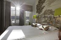 crisp and clean bedroom linens in Marais - Saint Claude luxury apartment