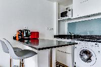 breakfast bar and modern kitchen in a studio Parisian apartment