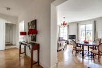 dining area with a round table and four chairs in a 2-bedroom Paris luxury apartment
