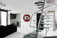 steel spiral staircases in a 3-bedroom Paris luxury apartment