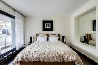 first bedroom with a double bed in Paris luxury apartment